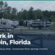 Header/social image showing multiple RVs and park frontage with trees and fencing; used as the McAlpin page social preview and provides a broader property view.