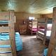 large bedroom with 4 bunk beds and a dresser