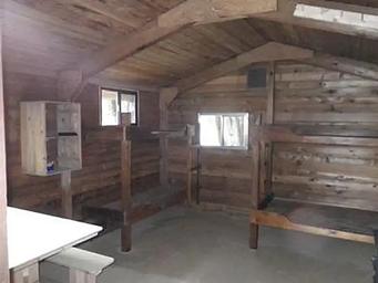 Harding River Cabin wood interior with wood bunkbeds and table