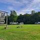 Entrance sign and open field with several RVs visible — shows campground layout and entry area. Image appears on the site’s main pages (https://tildenhillfarm.com/). Useful for property identification.