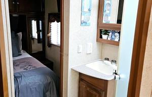 Large RV with outdoor kitchen, fireplace, and TVs
