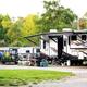 Ground-level view of RV sites and a fifth-wheel setup with site amenities and landscaping — from the community/gallery images on the property site, useful for illustrating typical RV pitches.