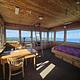 interior of a lookout, with bed, table and chair