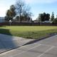 Grassy field area adjacent to paved roadway within the park — a property photo listed on the site's Photos page that helps show on-site open space and layout.
