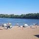 Swimming beach at Lazy L Lake with families enjoying the water