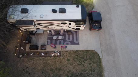 Top-down/drone view of a single RV site and patio area showing layout and amenities at site level — good detail for prospective guests. From the accommodations/rv-sites page.