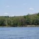 Wide river view showing the Potomac and wooded shoreline at the property (sunset/low-light) — from the homepage images, provides scenic overview of the campground’s river setting.