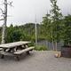 Picnic table with lake and forest in background