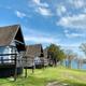 Row of A-frame lakeside cabins on grass sloping to the water — clearly shows on-site cabin accommodations and setting on Table Rock Lake. Appears in the property background/gallery pages.