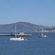 Sailing vessels anchored in Aquatic Park Cove. A view to the northeast under dramatic cirrus clouds with Alcatraz Island in background.