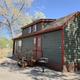 High-resolution exterior photo of a deluxe cabin (clear building, steps, grill and surroundings) from the 'Ways to stay' / cabins pages — good cabin property shot.