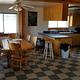 Inside of the Caretaker's cabin showing the kitchen and dining area with bar and table with 6 chairs