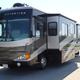 Well-lit front/side view of an Excursion motorhome with slide-out, parked on the property pavement; sourced from the site homepage showing fleet presentation (page: Motorhome Rentals and Service Center).