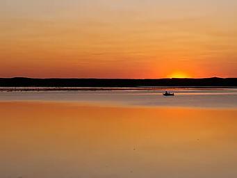 A lone boat out fishing on Lake Oahe at sunset at Hazelton Recreation Area