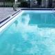 Photograph of the resort swimming pool and adjacent deck area (pool ladder, fencing, pool furniture visible). Sourced from the homepage (pool image), indicating an on‑property amenity.