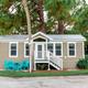 Exterior photo of a rental cabin on-site — shows cabin style and outdoor seating, matching the Cabin page content.