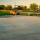 Concrete RV pad and adjacent landscaping with an old truck and fencing in the background, showing site context and fencing/landscape visible in the property’s rate/gallery images (page: /rates).