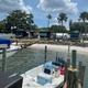 View from the water/dock showing boats and RVs lined along the shore — emphasizes marina access and RV slips, reinforcing on-site boat docking (from RV park/gallery pages).