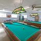 Interior recreation room with pool tables and ping-pong table — shows on-site clubhouse amenities listed on the resort page.