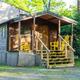 Cabin exterior with porch and seating — shows the campground's cabin lodging option and site surroundings.