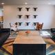 Interior lounge/common room with seating and ranch-themed decor — useful to show indoor guest facilities and accommodations available at the ranch.