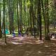 A serene landscape featuring a sunset over mountains and a calm lake reflecting the colors of the sky.