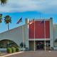 Front exterior of the main clubhouse/office with flagpoles and arched entry — useful overview of the resort's central facility as shown on the property page.  