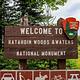 A close up of a National Park welcome sign on the way to Sandbank Stream Campground. It is wooden and says "Welcome to Katahdin Woods and Waters National Monument"