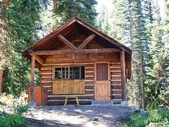 The front of a wooden cabin in a forest