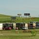 Clear wide view of multiple RVs on pull-through sites with picnic tables and grassy common areas — good overall overview of the RV park (source: Home page header image).
