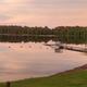 Wide lakeshore view showing the campground’s shoreline, docks and buoyed swim area at Cyclone Lake — useful for overall scenery and waterfront setting (image appears on the property homepage/shoreline page).