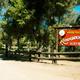 Entrance sign reading 'Woods Valley Kampground' with fencing and roadway — good exterior identification shot from the campground gallery (page: https://www.woodsvalley.com/our-campgound/).