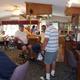 Interior view of a bar/lounge area with patrons — useful to show on-site amenities (Burnside Tavern / clubhouse) documented in the property gallery.
