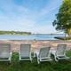 Beach and volleyball area with lounge chairs facing the lake — demonstrates the resort’s lakeside beach recreation spaces. Presented in the resort’s gallery on the property page (page: Lake Gaston RV Camping | Thousand Trails RV Campground, URL provided).