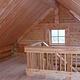 Middle Ridge Cabin interior showing wood stairs to loft