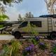 Shows an RV/van parked at a landscaped paved RV pad with campground-style plantings; file is from the campground's 'waystostayphotos' group on the property page, indicating an on-site RV accommodation view.