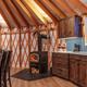 Yurt interior with granite countertops, sink, and cabinets