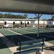 Covered shuffleboard/pickleball courts and seating area — shows on-site recreation amenities that appear in the resort’s photos and amenities listing.