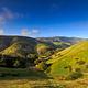 View of canyon nestled in low rolling, grass covered hills.