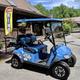 Photo of the campground’s rental golf cart parked in front of the store/office building — illustrates on-site amenities and the camp store area (from Amenities page).