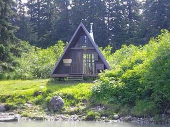 Shakes Slough 2 Cabin exterior of AFrame cabin with greenery surrounding it