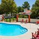 Clear photo of the property's swimming pool, deck chairs and landscaping — useful facility shot for the property gallery (comes from the site's Overview/about page).