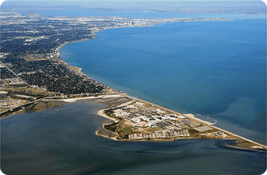 Aerial/coastal overview image of the peninsula and shoreline — useful as an overall location/landscape view for the campground's waterside setting (used on the park's fishing/water activities page).