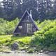 Shakes Slough 2 Cabin exterior of AFrame cabin with greenery surrounding it