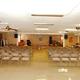 Large indoor meeting/activity room with chairs and a stage — represents clubhouse/community interior spaces for guests (included on the Capri RV Resort page).