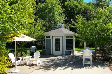 Ground-level photo of a gazebo seating area with landscaping and chairs — good depiction of campground amenity and outdoor common space from the 'Rent A Premium Site' content.