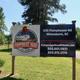 Entrance sign with property name, address and web/phone — confirms property identity and shows roadside frontage (from the gallery page).