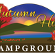 Wide photo showing wooded hillside and lake/grounds used as the site’s main social image on the homepage; clearly depicts the campground’s landscape and setting (supports homepage text about being adjacent to Daniels Lake).