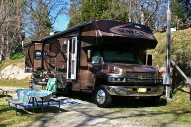 Single large RV on a dedicated site with picnic table and hookups visible; useful detail of an individual RV site and setup (site selection page image).