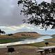 Campsite within Buckhorn Campground showing picnic table, firepit, and the view of the lake.